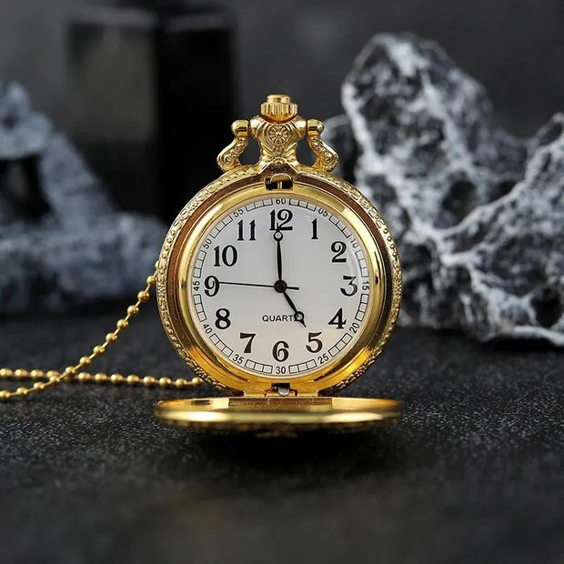 Elegant gold pocket watch featuring engraved details and chain.