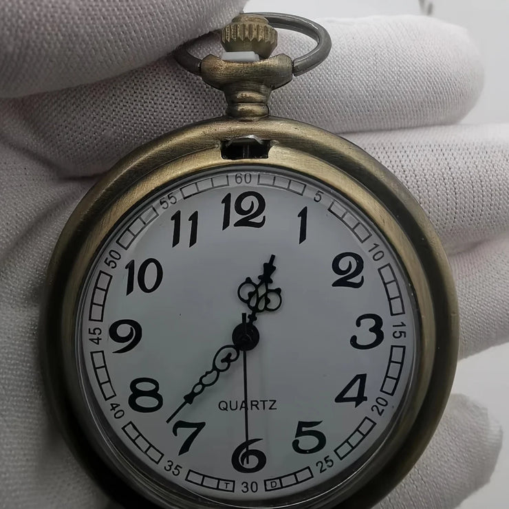 Bronze pocket watch with a classic white dial, black numerals, and quartz movement, combining functionality with vintage style.