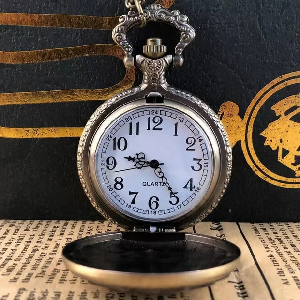 Open vintage bronze pocket watch with a white quartz dial, black Arabic numerals, and ornate detailing. Stylish accessory for all ages.