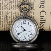 Pocket watch with intricate engravings and a metal chain.